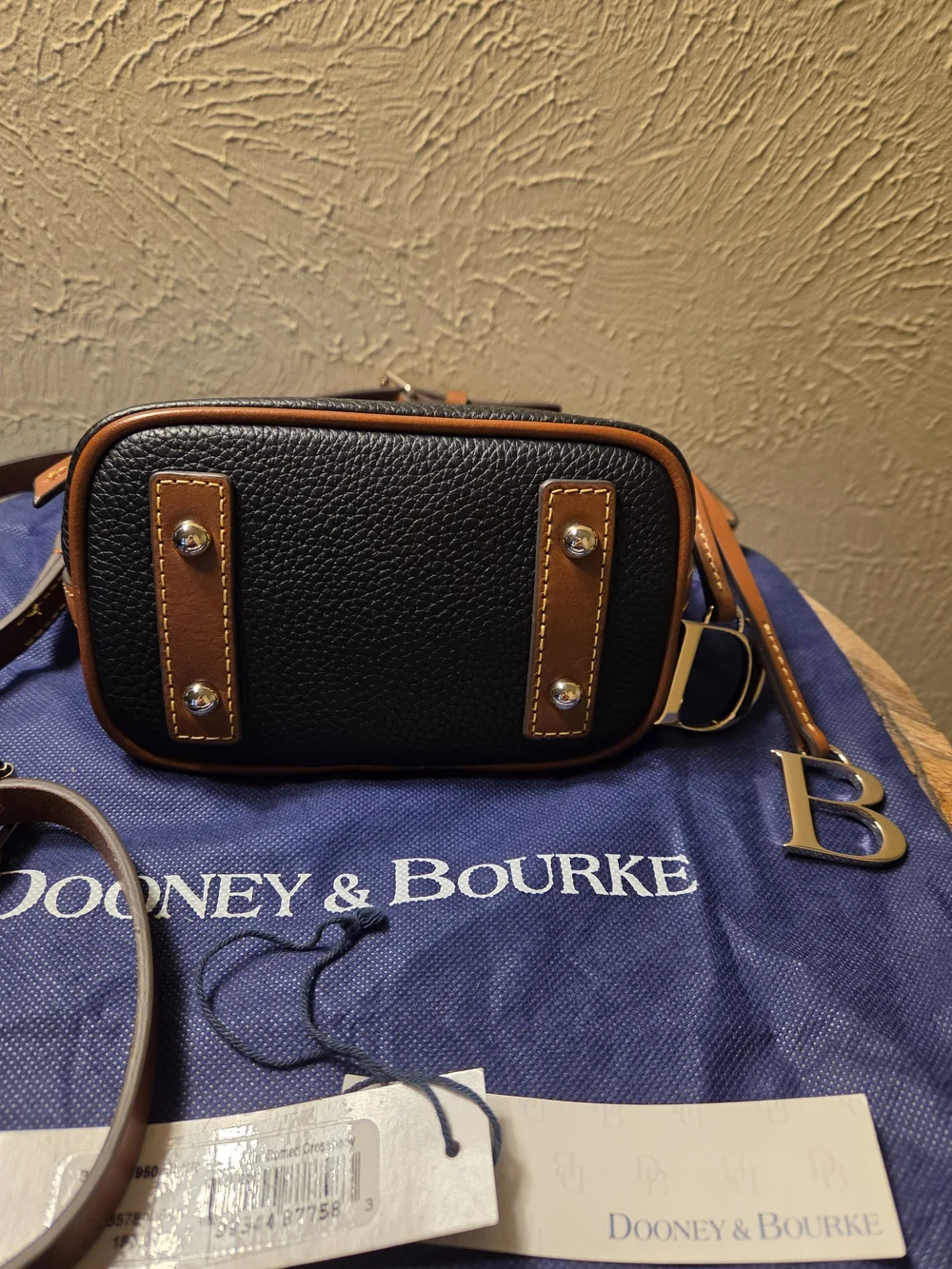 Dooney & Bourke NWT Black Pebble Leather Crossbody with Brown Trim. Logo charms
